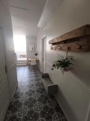 a hallway with a stairway with a table and a plant at Appartement, 3 pièces, Villa Monte Europa in Nice