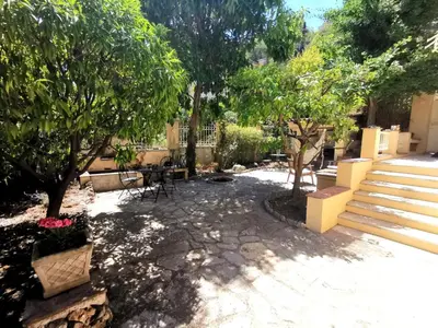 a patio with trees and a table and chairs at Chambre privée luxueuse Villa Monte 0ropa in Nice
