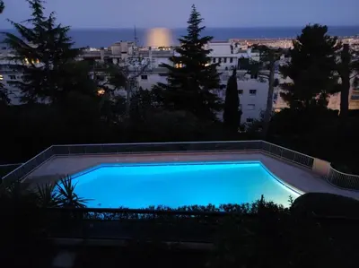 a blue swimming pool with a view of the city at Nice Absea Corniche Fleurie in Nice