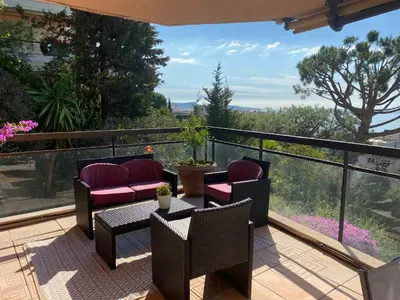 a balcony with chairs and a table with a view at Nice Absea Corniche Fleurie in Nice