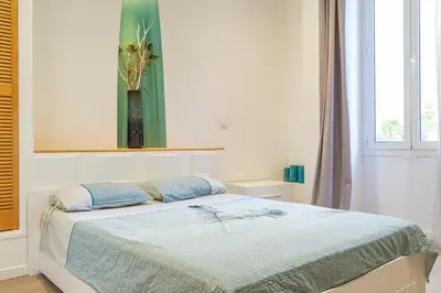 a bedroom with a bed with a vase on the wall at Nice: hyper centre !Super appartement cosy in Nice