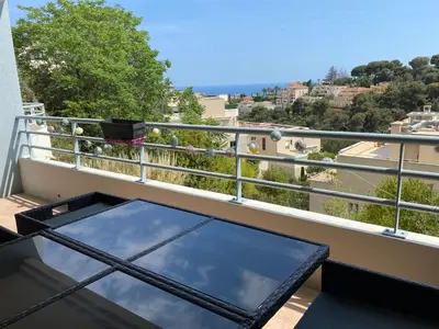 a balcony with a glass table on a balcony at Nice Absea Fabron 1 in Nice