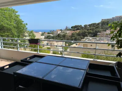 a table on a balcony with a view of the city at Nice Absea Fabron 1 in Nice