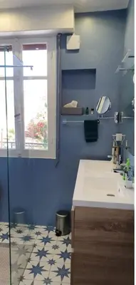 a blue bathroom with a sink and a window at SoNiceRiviera in Nice
