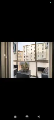 a view of a living room with a large window at Super appartement au cœur de Nice! Bonnes vacances in Nice