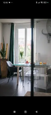 a living room with a glass table and a window at Super appartement au cœur de Nice! Bonnes vacances in Nice