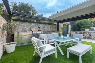 a patio with a table and chairs and a grill at Deluxe VILLA GRAZIELLA 200 M FROM THE BEACH in Èze