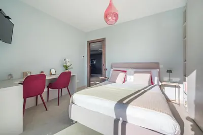 a bedroom with a bed and a desk and chairs at Deluxe VILLA GRAZIELLA 200 M FROM THE BEACH in Èze