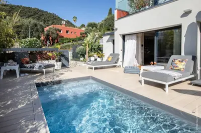 a patio with a swimming pool and a house at Deluxe VILLA GRAZIELLA 200 M FROM THE BEACH in Èze