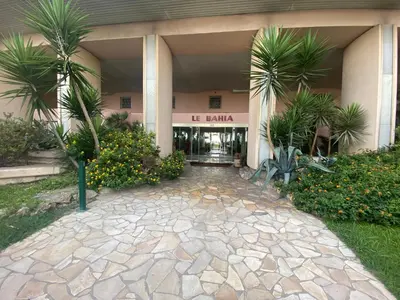a building with palm trees in front of it at LE BAHIA in Nice
