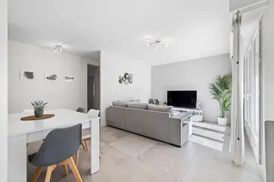a living room with a couch and a table at Le Hammam Azur in Nice