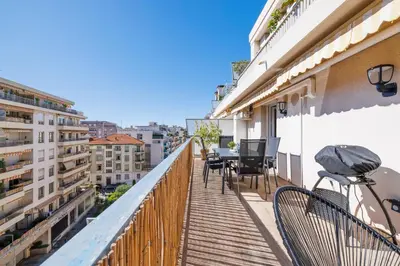 a balcony with chairs and tables on a building at Le Hammam Azur in Nice
