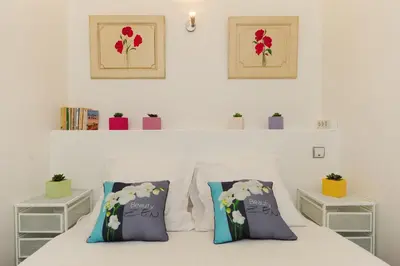 a white bedroom with two pillows on a bed at PV STUDIO Five Stars Holiday House in Nice