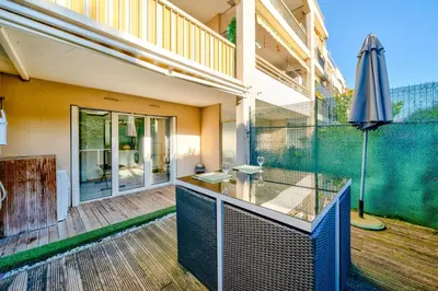 an empty patio with an umbrella on a deck at Charmant studio in Cagnes-sur-Mer