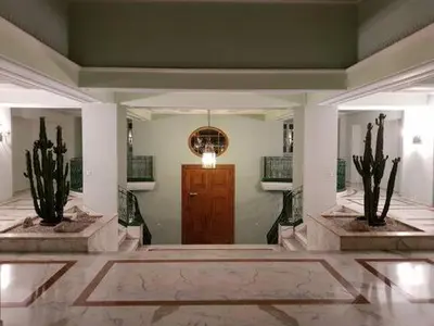 a lobby with two plants and a wooden door at Port de Nice- Résidence Neptune- Superbe studio! in Nice