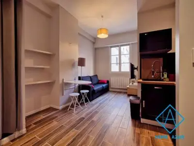 a living room with a couch and a table at Port de Nice- Résidence Neptune- Superbe studio! in Nice