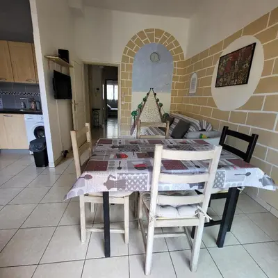 a kitchen with a table and chairs in a room at Cœur d'azur in Saint-Laurent-du-Var