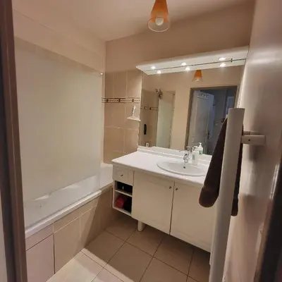 a bathroom with a sink and a mirror and a tub at Cœur d'azur in Saint-Laurent-du-Var