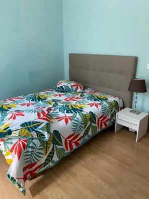 a bed with a colorful comforter in a bedroom at Maison le Rêve in Falicon