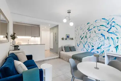 a living room with a blue fish mural on the wall at AZUR Apartment - Quiet City Center Location by the Sea in Nice