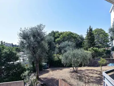 a view of a yard with trees in the background at Apartment Cimiez Les Pins by Interhome in Nice