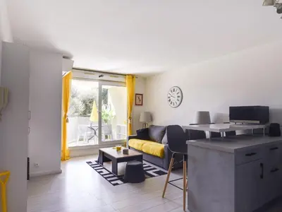 a living room with a couch and a table at Apartment Cimiez Les Pins by Interhome in Nice