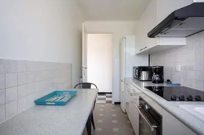 a kitchen with a counter with a sink and a stove at Apartment T2 air-conditioned sea view in Saint-Laurent-du-Var