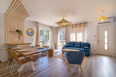 a living room with a blue couch and a table at Magnifique pavillon indépendant T2 Nice in Nice