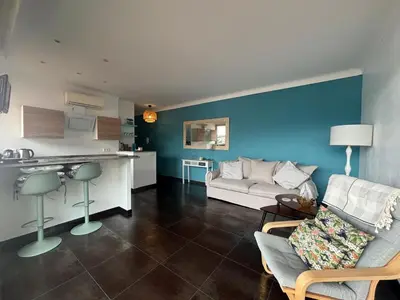 a living room with a couch and a kitchen at Excellent location - Sea Views in Villefranche-sur-Mer
