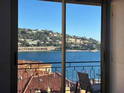 a view of the water from a room with a window at Excellent location - Sea Views in Villefranche-sur-Mer