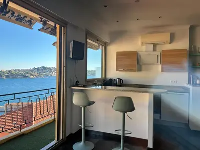 a kitchen with a counter and a view of the water at Excellent location - Sea Views in Villefranche-sur-Mer