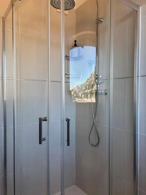 a shower with a glass door in a bathroom at Excellent location - Sea Views in Villefranche-sur-Mer