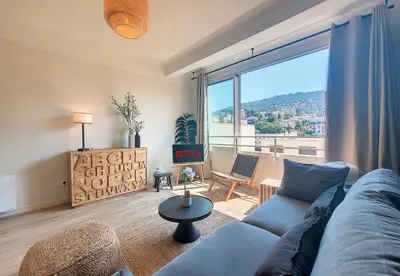 a living room with a blue couch and a large window at Nestor&Jeeves - BLUE PEARL - Port area - Close Old Town in Nice
