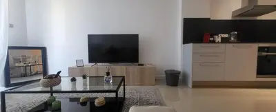 a living room with a tv and a coffee table at cagnes promenade in Cagnes-sur-Mer
