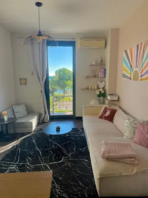 a kitchen and living room with a table and a refrigerator at Appartement Nice Promenade in Nice