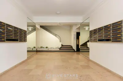 a hallway of a library with bookshelves and a staircase at Suite Reine Marie FSHH in Nice
