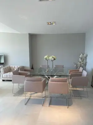 a dining room with a glass table and chairs at Villa LA ALEGRIA in Nice