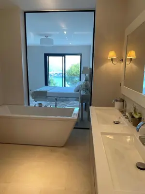 a bathroom with a tub and a bed in a mirror at Villa LA ALEGRIA in Nice