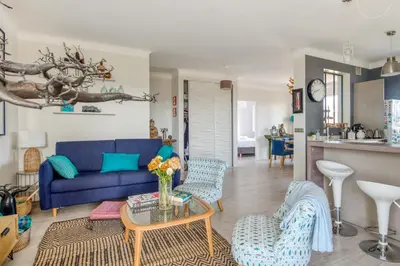 a living room with a blue couch and chairs at Appartement Ayres - Welkeys in Nice