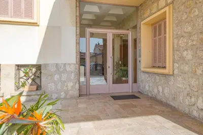 a house with a pink door and a window at Appartement Ayres - Welkeys in Nice
