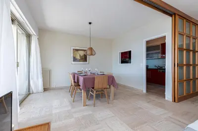 a dining room with a table and chairs at Amazing Sea View 2Bdr Swimming Pool Parking in Villefranche-sur-Mer