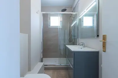 a bathroom with a shower and a sink and a toilet at Amazing Sea View 2Bdr Swimming Pool Parking in Villefranche-sur-Mer