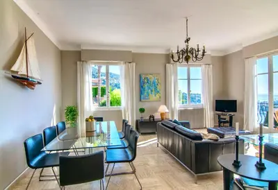 a living room with a couch and a table at Villa Soleil d'Or in Villefranche-sur-Mer