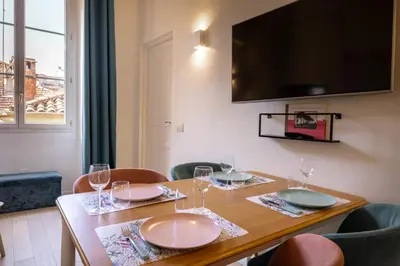 a small bedroom with a bed with pink pillows at 06A3 - Lovely apartment in the heart of old Nice in Nice