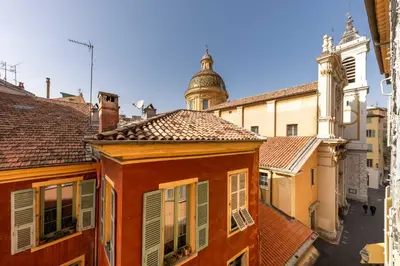 a bedroom with a large bed and a dining room at 06A3 - Lovely apartment in the heart of old Nice in Nice