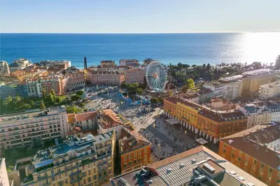 a table with a book and glasses and a bowl of fruit at 06A3 - Lovely apartment in the heart of old Nice in Nice