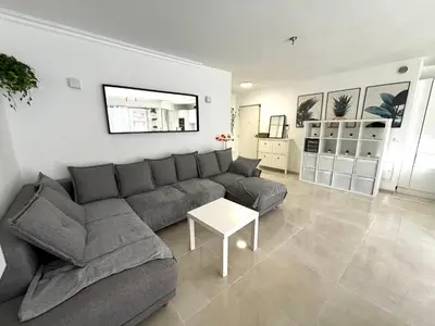a living room with a gray couch and a table at Appartement 6 pers Port de Nice, mer et Vieux-Nice à pied in Nice