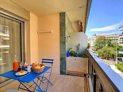 a blue table and chairs on a balcony with a refrigerator at BLUE RIVIERA TERRACE CENTRAL TRAIN STATION in Nice