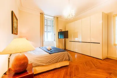 a bedroom with a bed with a cat on it at PALAIS ALBERT 1ER AP4292 By Riviera Holiday Homes in Nice