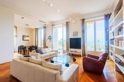 a living room with two couches and a television at PALAIS ALBERT 1ER AP4292 By Riviera Holiday Homes in Nice
